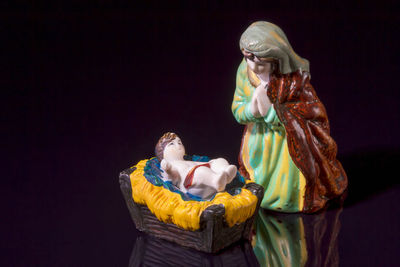 Statues showing birth of jesus christ against black background