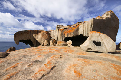 Remarkable rocks by sea against sky