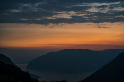 Scenic view of silhouette mountains against sky at sunset