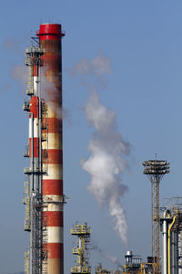 Low angle view of smoke stack against sky