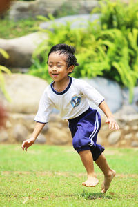 Boy smile while running in the field