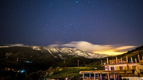 Scenic view of mountains against sky at night
