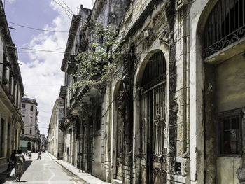 Low angle view of street amidst buildings in city