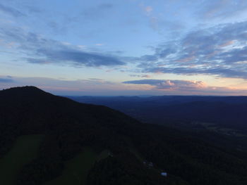 Scenic view of mountains against sky at sunset