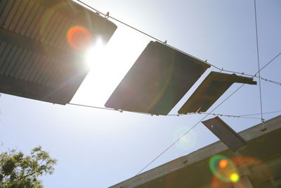 Low angle view of flags hanging on sunny day