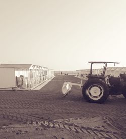 Horse cart on beach against clear sky