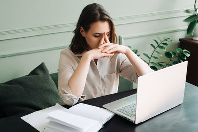 Young woman using laptop at home