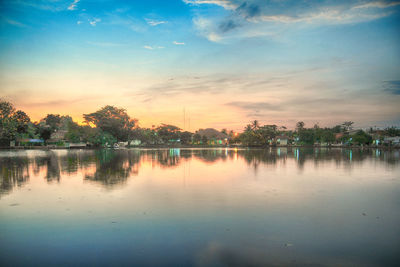 Scenic view of lake against sky at sunset