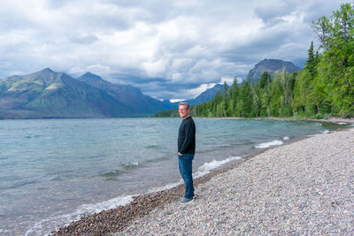 Full length of man standing on mountain against sky