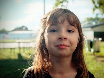 Close-up portrait of girl standing outdoors