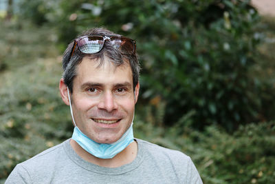 Portrait of a smiling young man with mask