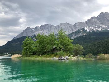 Scenic view of lake and mountains against sky