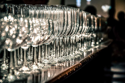 Empty wineglasses arranged on counter in bar