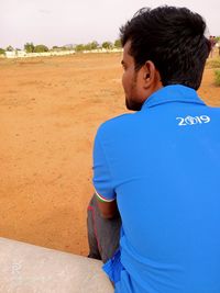 Rear view of young man looking away