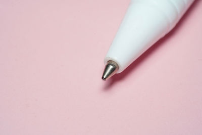 Close-up of cigarette over white background