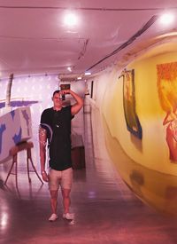 Rear view of man photographing in bus