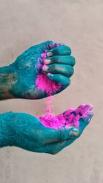 Cropped hands of woman holding powder paints