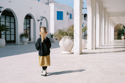 Portrait of young woman standing in city