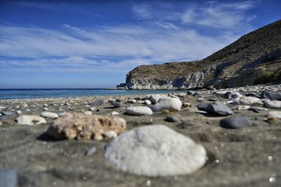 Scenic view of beach against cloudy sky