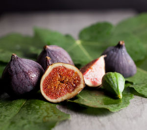 Close-up of fruits and leaves on table