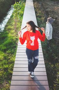 High angle view of woman standing on footpath
