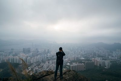 Rear view of looking at cityscape