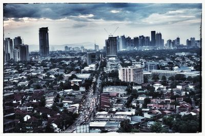 Cityscape against cloudy sky