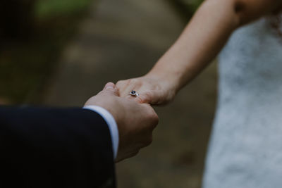 Midsection of couple holding hands