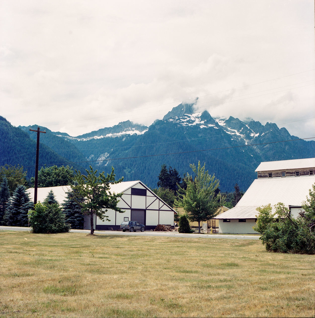 mountain, architecture, building exterior, built structure, sky, plant, building, tree, nature, house, environment, land, landscape, field, no people, beauty in nature, day, scenics - nature, residential district, mountain range, outdoors, mountain peak