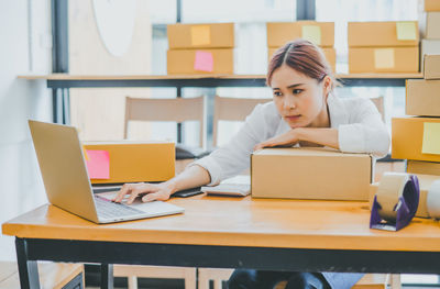 Businesswoman using laptop at office