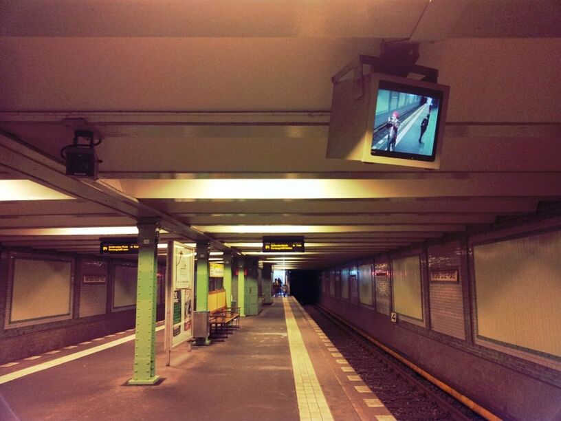 transportation, the way forward, architecture, built structure, diminishing perspective, railroad track, rail transportation, illuminated, indoors, railroad station platform, railroad station, vanishing point, public transportation, ceiling, lighting equipment, men, mode of transport, incidental people