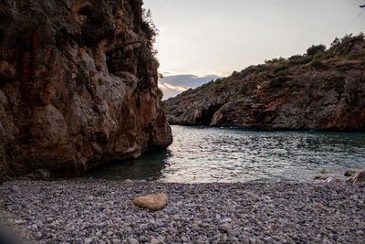 Rocks on beach against sky