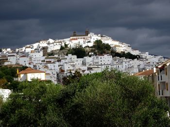 High angle view of townscape by sea against sky