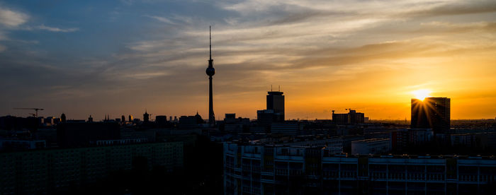 Buildings in city during sunset