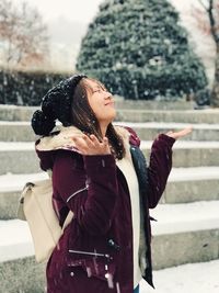 Young woman enjoying in snow