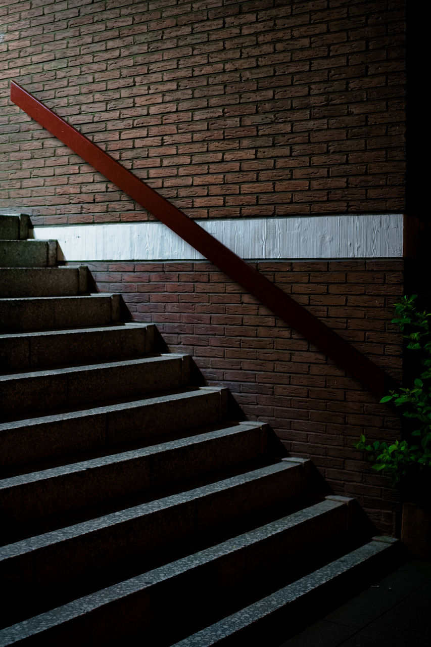 staircase, steps and staircases, architecture, stairs, built structure, no people, railing, wall, wood, light, line, darkness, low angle view, pattern, building exterior, wall - building feature, day, nature, outdoors, brick
