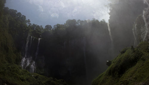 Panoramic view of waterfall against sky