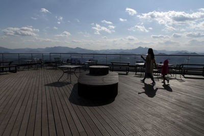 People on rooftop against sky