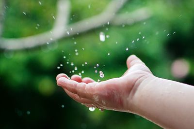Close-up of hand on water