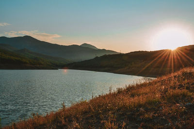 Scenic view of lake against sky during sunset