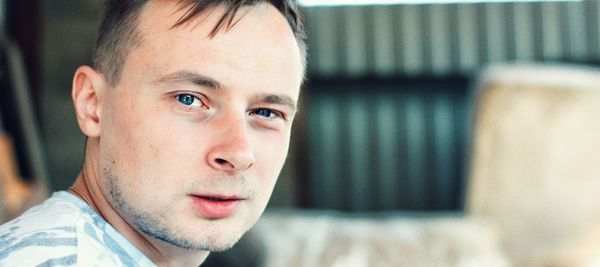 Close-up portrait of young man looking away