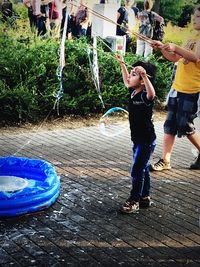 Full length of boy playing in water
