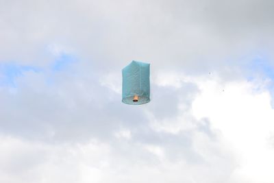 Low angle view of helicopter flying against sky