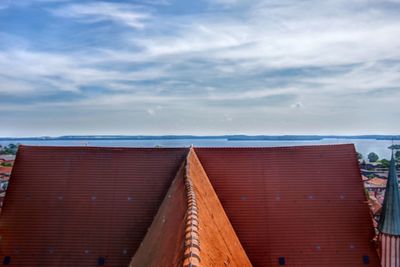 Exterior of building by sea against sky