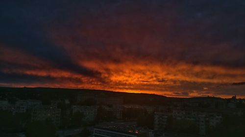 Silhouette cityscape against sky during sunset