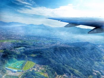 Cropped image of airplane flying over landscape