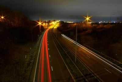 High angle view of light trails on highway at night