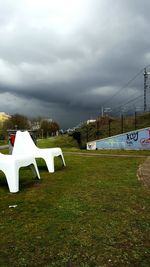 View of grassy field against cloudy sky