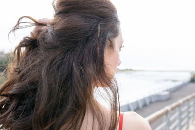 Rear view of woman with long hair against sky