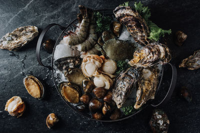 High angle view of various seafood in bowl on table